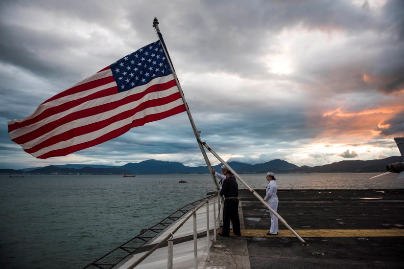 Sailors perform evening colors.